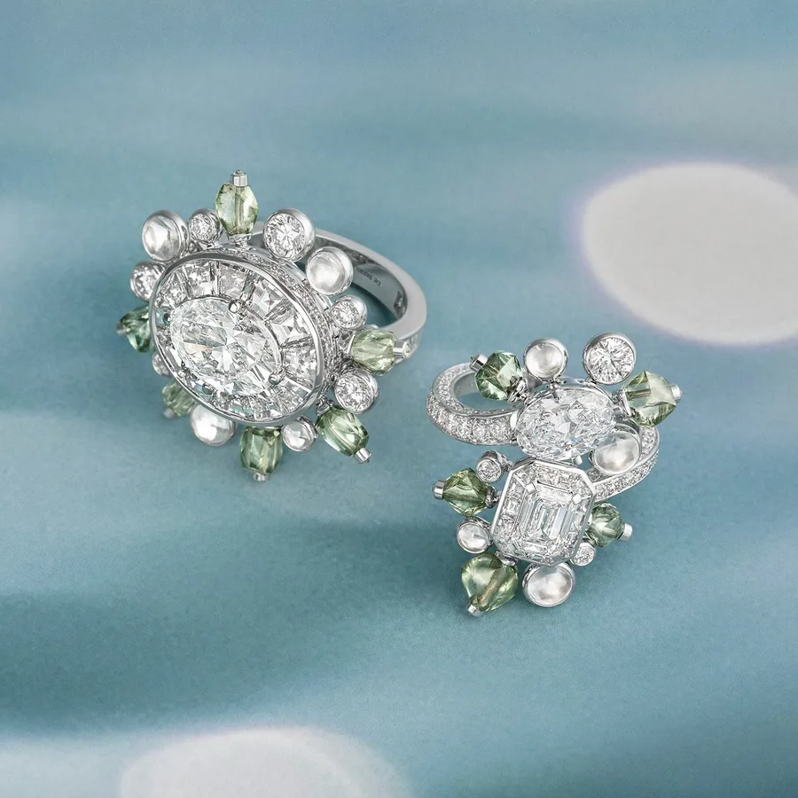 Two Undulation rings by De Beers London with rough green diamonds and cabochon-cut diamonds