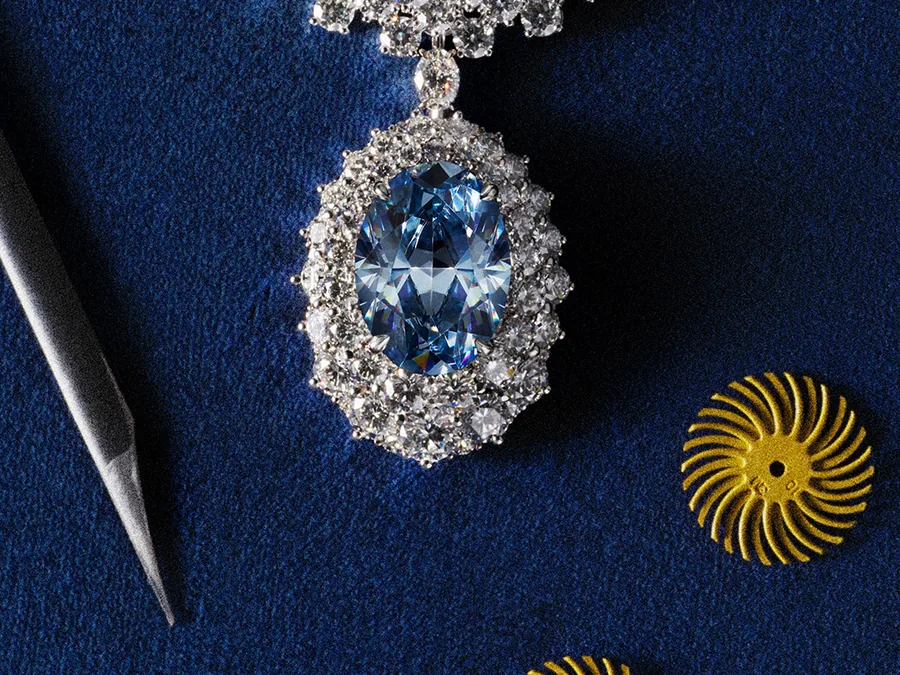 Messika Okavango Blue necklace with the 20.46-carat Fancy Deep Blue diamond from Botswana beside jeweler’s tools